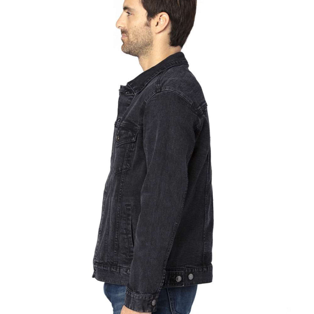 studio side-view of a male model wearing a plain black denim jacket showing seams, pockets, and fit with no artwork printed