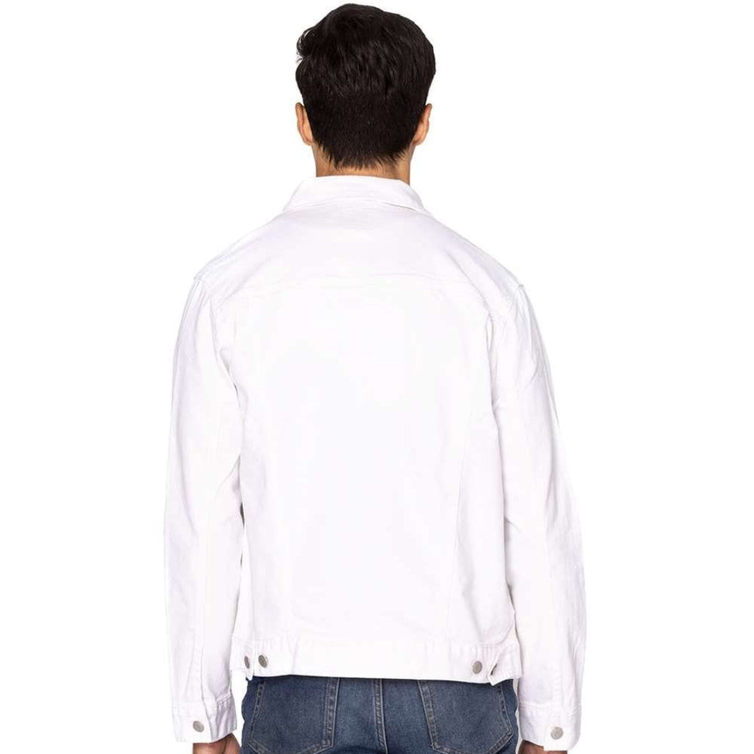 back view of a male model standing in a studio wearing a plain white unisex retail-fit style classic-cut denim jacket showing stitching and clean print panel with no artwork
