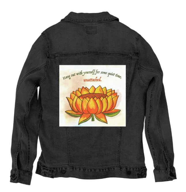 back view of a black denim jacket showcasing the artwork “Be Unattached” by Canvas & Quotations, depicting an orange lotus flower with the text “Hang out with yourself for some quiet time, unattached.” the artwork is digitally printed on the jacket’s back panel by DenimINK