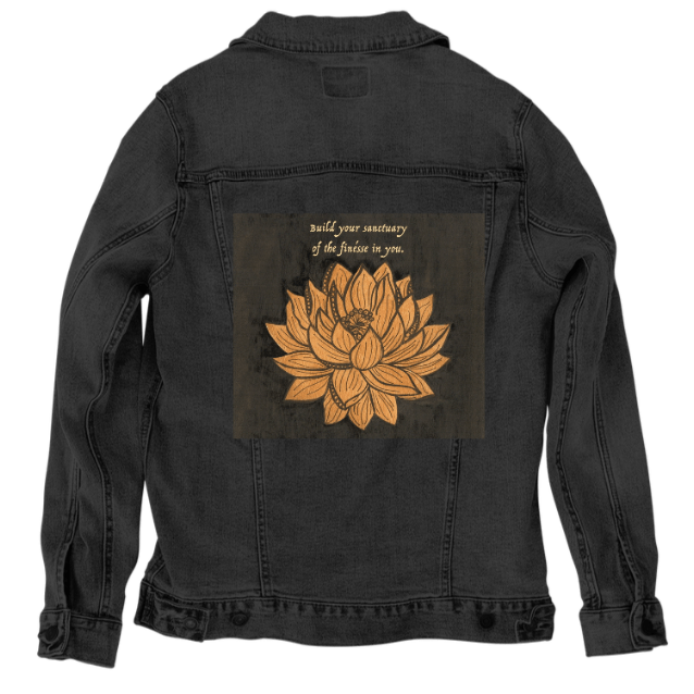 back view of a black denim jacket showcasing the artwork “Be Your Own Sanctuary” by Canvas & Quotations, featuring a golden lotus flower beneath an inspirational quote on a deep textured background. the artwork is digitally printed on the jacket’s back panel by DenimINK