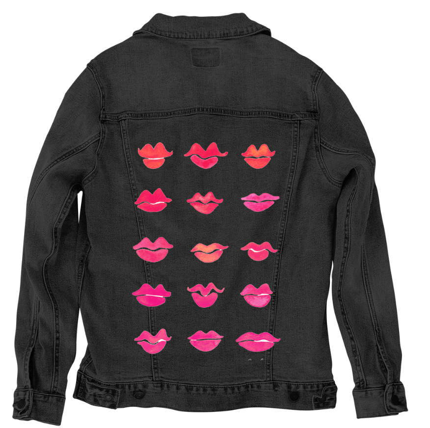 back view of a black denim jacket printed with the “Kiss Collection” by CatCoq, featuring fifteen lips arranged in neat rows. each lip is hand-painted in vibrant pink, coral & red tones, with soft shading & variation in shape. the lips appear to float in a symmetrical grid centered on the back panel. the bold colors stand out sharply against the dark fabric. printed by DenimINK.