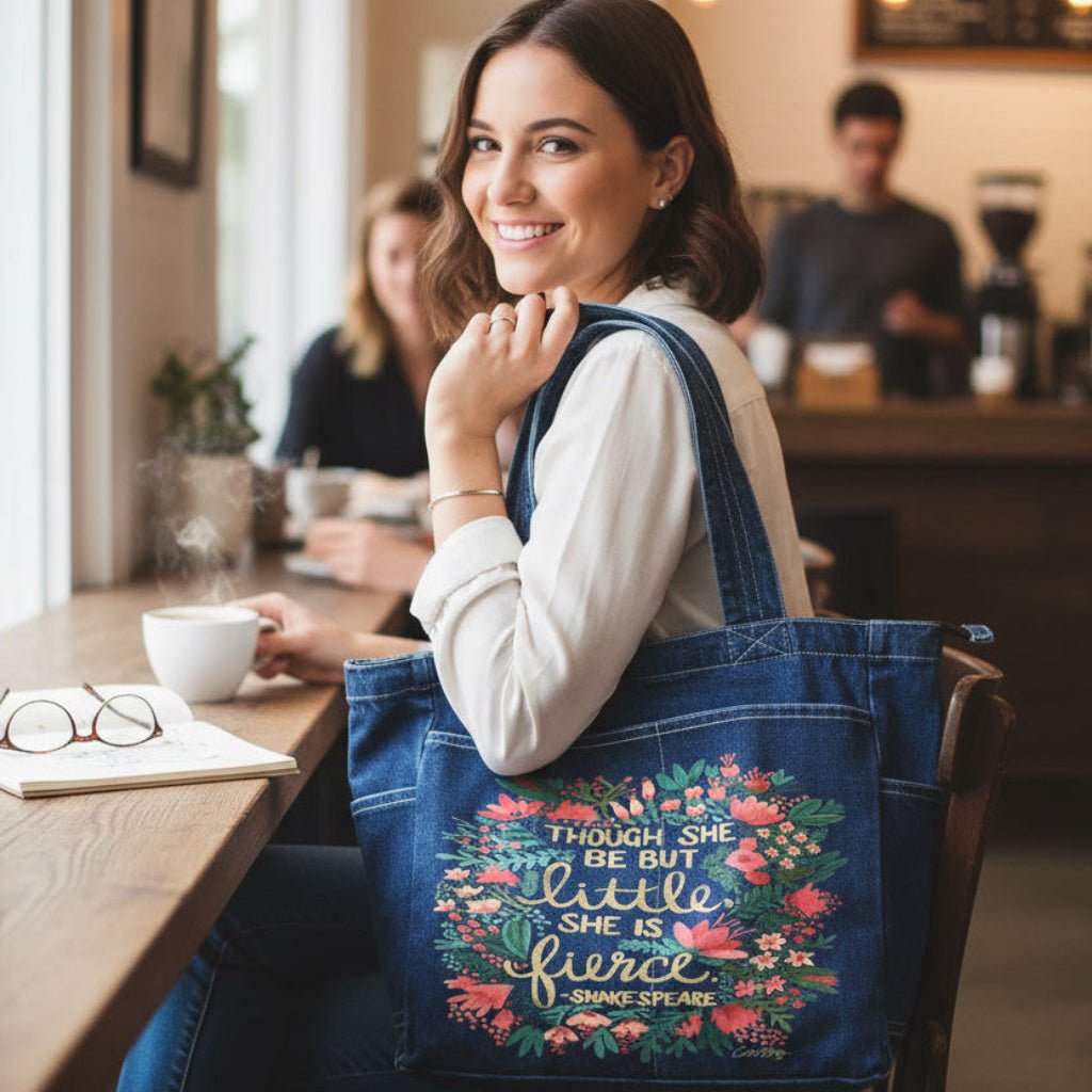 Woman sitting at a cafe with a floral tote bag with Shakespears text "Though She Be But Little, She is Fierce" printed by DenimINK.
little-and-fierce-catcoq-tote_bag-lifestyle-shot