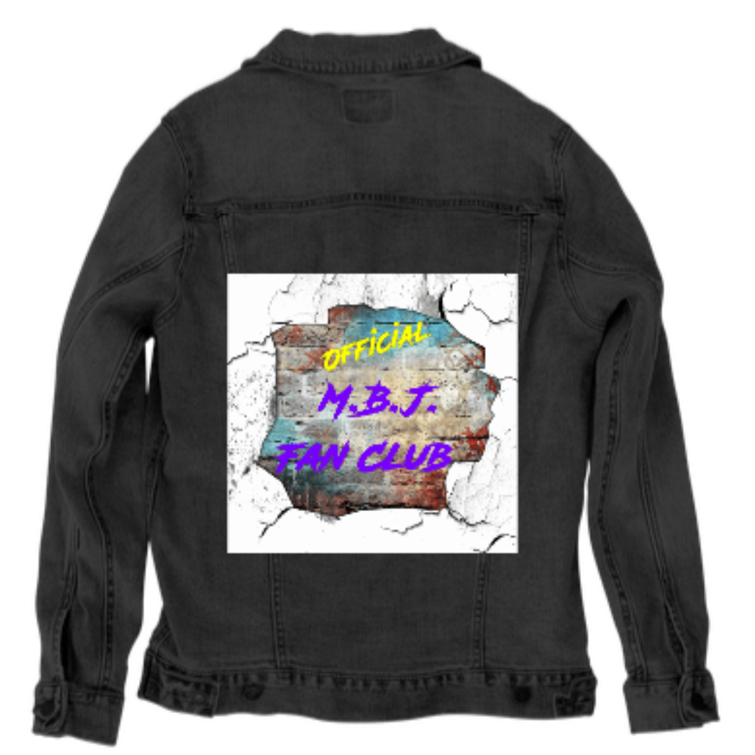 Back view of a black stonewashed denim jacket shown as a studio mockup, featuring a centered square artwork with a cracked-wall illusion. Jagged white edges break open to reveal layered textures of rust, teal, and weathered concrete beneath bold yellow and purple text reading “OFFICIAL M.B.J. FAN CLUB.” The dark denim absorbs light, making the artwork feel intense, gritty, and charged with underground fan energy.