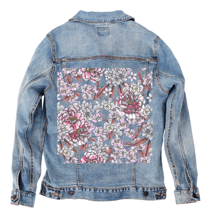 back view of a stonewashed denim jacket featuring a soft floral panel of pale pink, white & rose-colored peonies with pencil-drawn linework & blush-toned leaves. the artwork “Pink Afternoon” by Cecilia Battaini is digitally printed on the jacket’s back panel by DenimINK.