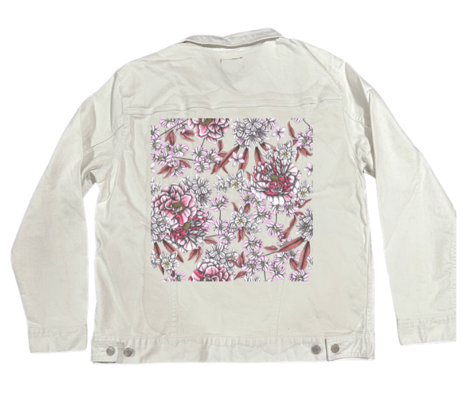 back view of a white denim jacket featuring a crisp panel of blooming peonies & clustered blossoms shaded in pencil textures, pink tints & ivory tones, with fine dusty rose leaves layered beneath. the artwork “Pink Afternoon” by Cecilia Battaini is digitally printed on the jacket’s back panel by DenimINK.