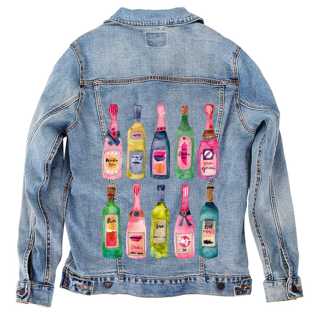 back view of a stonewashed denim jacket featuring the artwork “Champagne Collection” by CatCoq, digitally printed on the back. the design includes twelve watercolor champagne bottles arranged in two rows, each one uniquely colored in shades of pink, yellow, green, and blue. the faded texture of the denim adds a soft, vintage feel to the composition while allowing the bottle details to remain sharp and lively. printed by DenimINK on a unisex handcrafted jacket.