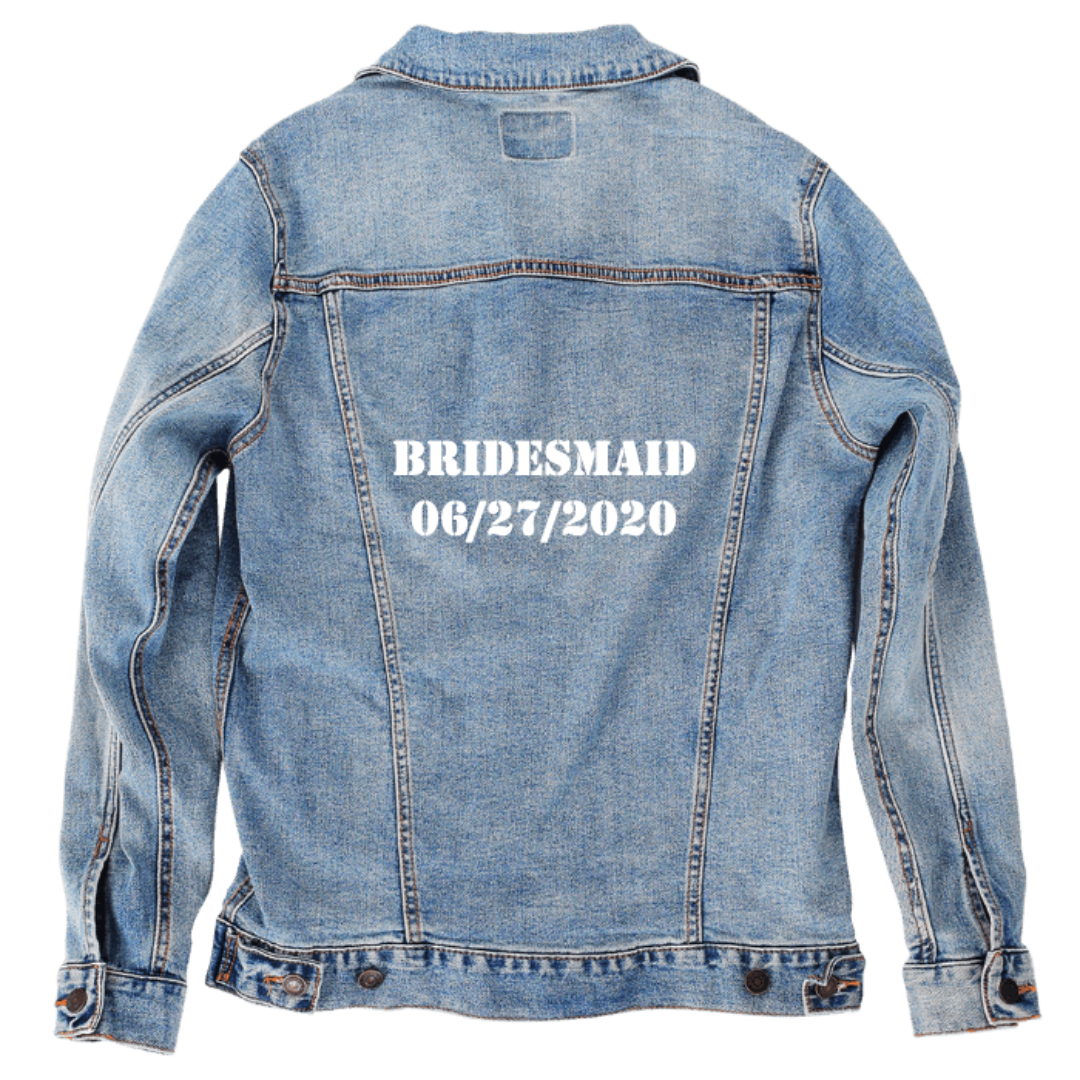 Customer designed custom denim jacket (L stonewash) featuring bold white stencil-style lettering across the back that reads “BRIDESMAID” above the date “06/27/2020.” The crisp block text stands out sharply against the soft, faded blue denim, creating a personalized wedding-themed design with a clean, celebratory feel, printed on denim jacket by DenimINK.