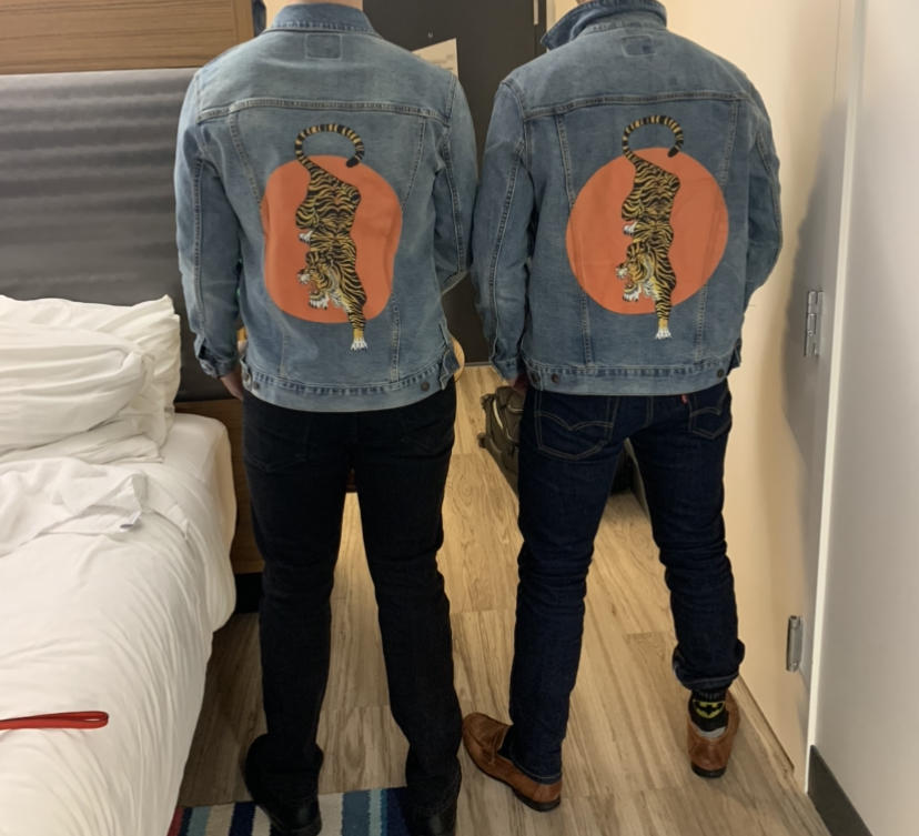 Fan Feature Friday — two friends wearing matching tiger-print denim jackets designed for a bachelor party, handcrafted by DenimINK