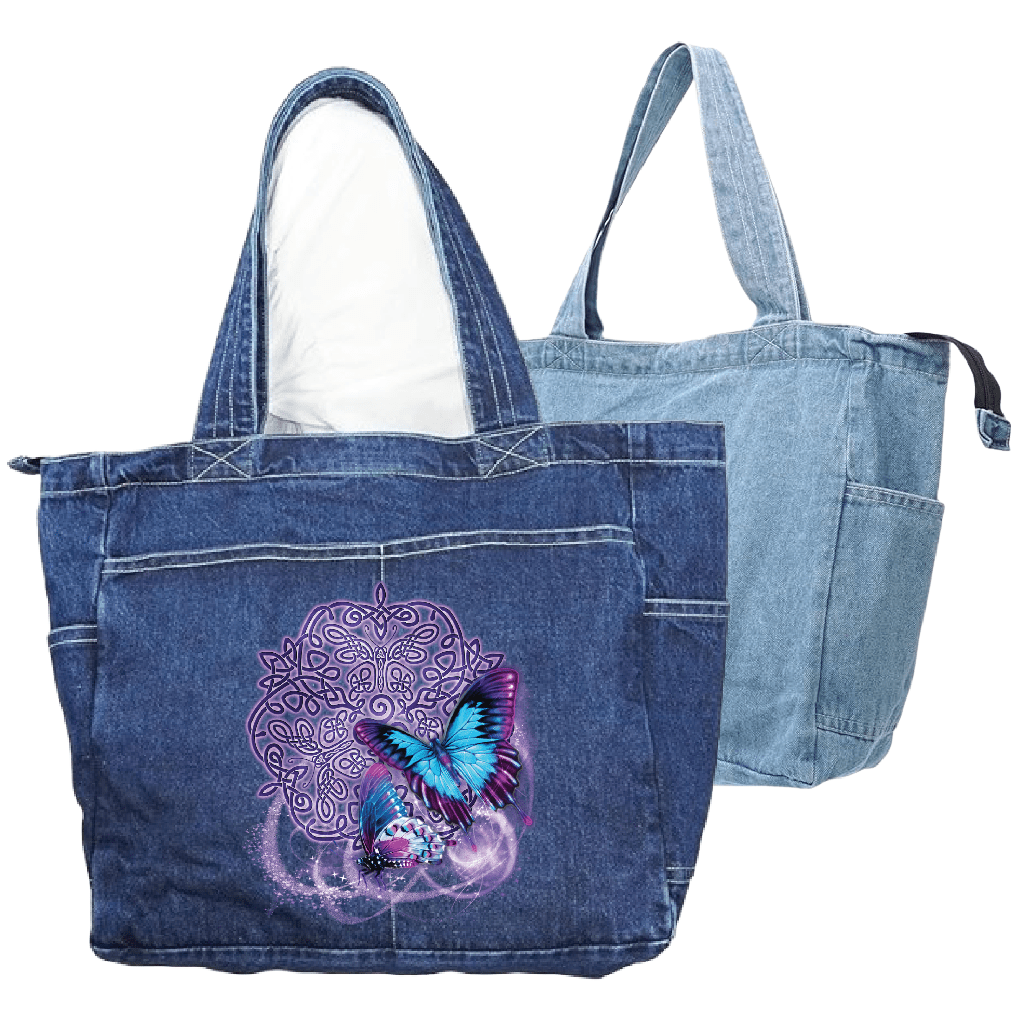 front view of a classic blue denim tote bag and back view of a stonewashed denim tote bag featuring the artwork “Celtic Butterfly” by Brigid Ashwood, printed large and centered on the front panel. the design shows two luminous blue and purple butterflies in flight over an intricate Celtic knotwork motif with soft glowing accents. the artwork contrasts clearly against the textured blue denim. the zippered tote bag features reinforced handles and exterior pockets. digitally printed by DenimINK.