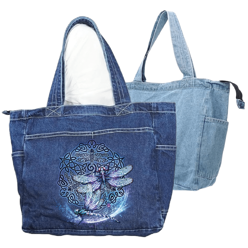 front view of a classic blue denim tote bag and back view of a stonewashed denim tote bag featuring the artwork “celtic dragon” by brigid ashwood, printed large and centered on the front panel. the artwork shows a seated dragon with green, teal, and purple scales in front of a circular celtic knotwork motif in deep green and red tones. the zippered tote bag includes reinforced handles and exterior pockets. digitally printed by DenimINK.