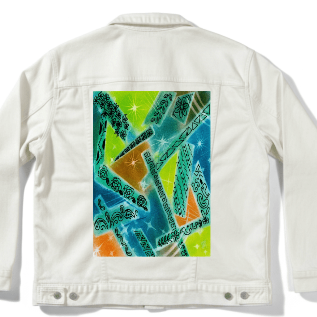 white denim jacket mockup with abstract artwork featuring overlapping shapes in green, blue, orange, and yellow with spray-paint texture, scattered starbursts, and hand-drawn floral, leaf, and geometric line motifs arranged throughout the composition. this artwork is titled “Abstract Magic” and created by Canvas &amp; Quotations (Monika Chugh and Alka Chopra) printed by DenimINK