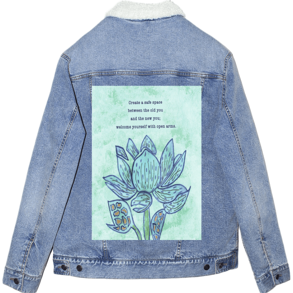 sherpa-lined stonewashed denim jacket with mockup featuring a blue lotus flower on a textured light-green background, paired with the quote “Create a safe space between the old you and the new you; welcome yourself with open arms.” the artwork is titled “Always Welcome Yourself” and created by Canvas &amp; Quotations (Monika Chugh and Alka Chopra) and printed by DenimINK