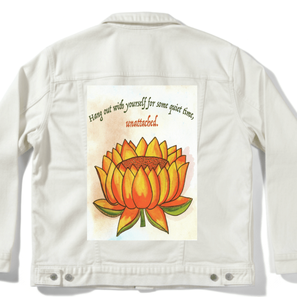 back of white denim jacket mockup  featuring a warm-toned orange lotus flower on a textured background, paired with the quote “Hang out with yourself for some quiet time, unattached.” rendered in green and red script. this artwork is titled “Be Unattached” and created by Canvas &amp; Quotations (Monika Chugh and Alka Chopra) printed by DenimINK