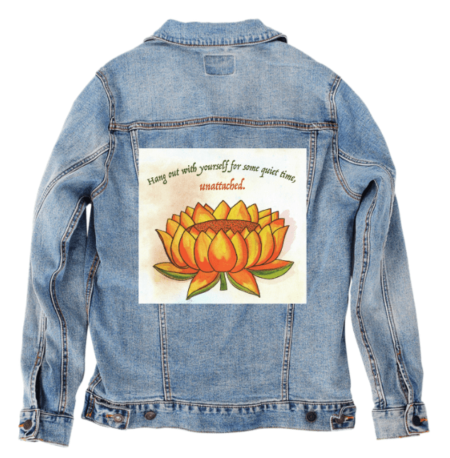 stonewash denim jacket printed with “Be Unattached” by Canvas &amp; Quotations, showing an orange lotus and inspirational quote, printed by DenimINK