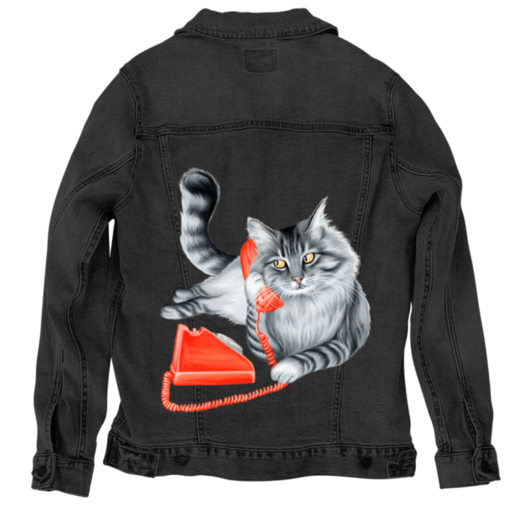 back view of a black denim jacket laid flat, featuring the artwork “Cat on the Phone” by Amélie Legault, showing a gray cat holding a red vintage telephone. the artwork is digitally printed on the jacket’s back panel by DenimINK