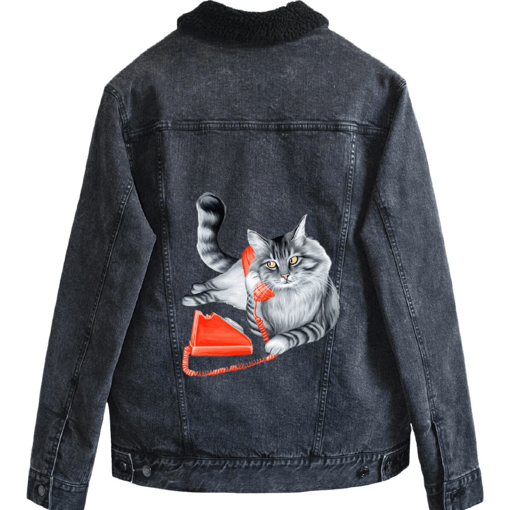 Mock up of a fluffy gray long-haired cat reclining with its tail curled upward, holding a bright red vintage telephone receiver to its ear Digitally printed by DenimINK on a Serpa-lined unisex black denim jacket.  the cat’s fur is rendered in layered charcoal and silver tones with fine whisker lines and golden-yellow eyes gazing forward. a matching red phone base and coiled cord rest below. titled “Cat on the Phone” created by by Amélie Legault 