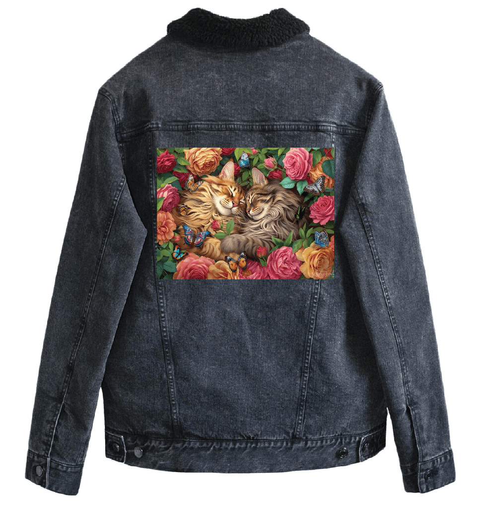 back view of a black denim jacket with a black sherpa-style liner featuring the artwork “Cats in Love” by Brigid Ashwood, printed centered on the back panel. the artwork shows two long-haired cats resting cheek to cheek among blooming roses and green foliage, with small colorful butterflies throughout the floral scene. the warm, romantic colors contrast clearly against the dark denim. digitally printed by DenimINK.