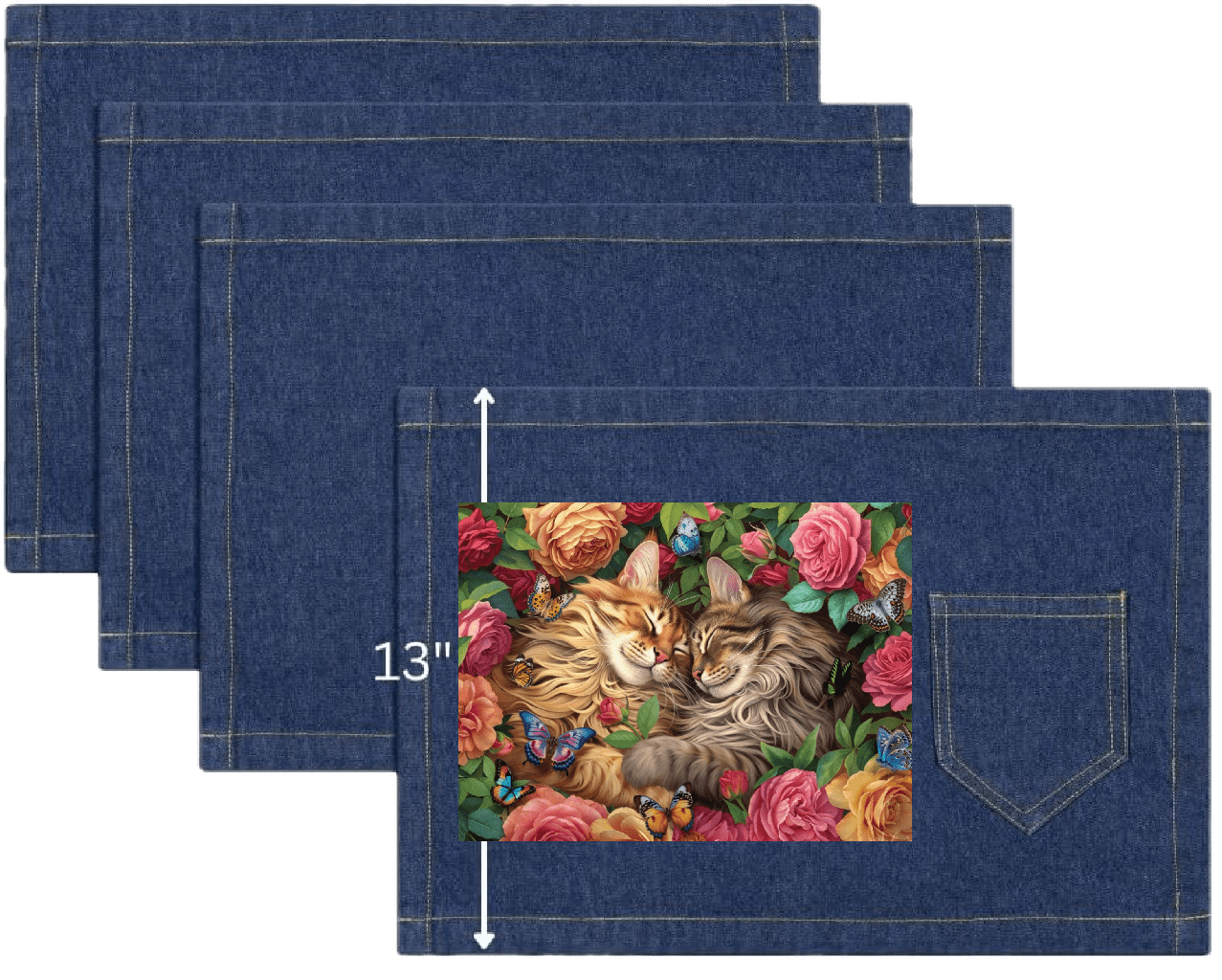 top view of four classic blue denim table placemats featuring the artwork “Cats in Love” by Brigid Ashwood, printed centered on the surface. the artwork shows two long-haired cats resting cheek to cheek, surrounded by blooming roses and green foliage, with small butterflies scattered throughout the floral scene. visible white measurement text and arrow indicate a height of 13 inches on the placemat. placemat includes a stitched pocket and one-inch stitched seams. digitally printed by DenimINK.
