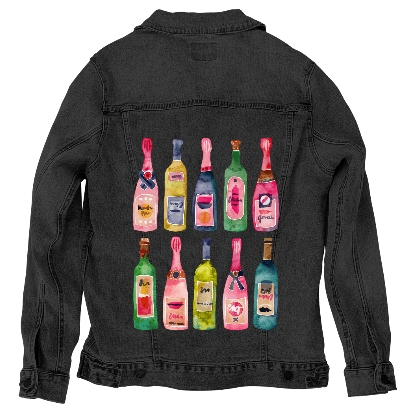 back view of a black denim jacket featuring the artwork “Champagne Collection” by CatCoq, digitally printed on the back panel. the design displays twelve unique watercolor-painted champagne bottles in two rows, with color schemes ranging from pinks and golds to forest green, navy, and soft blue. the vibrant tones stand out vividly against the dark fabric, with each bottle featuring its own playful label or foil wrap design. the artwork is digitally printed by DenimINK.