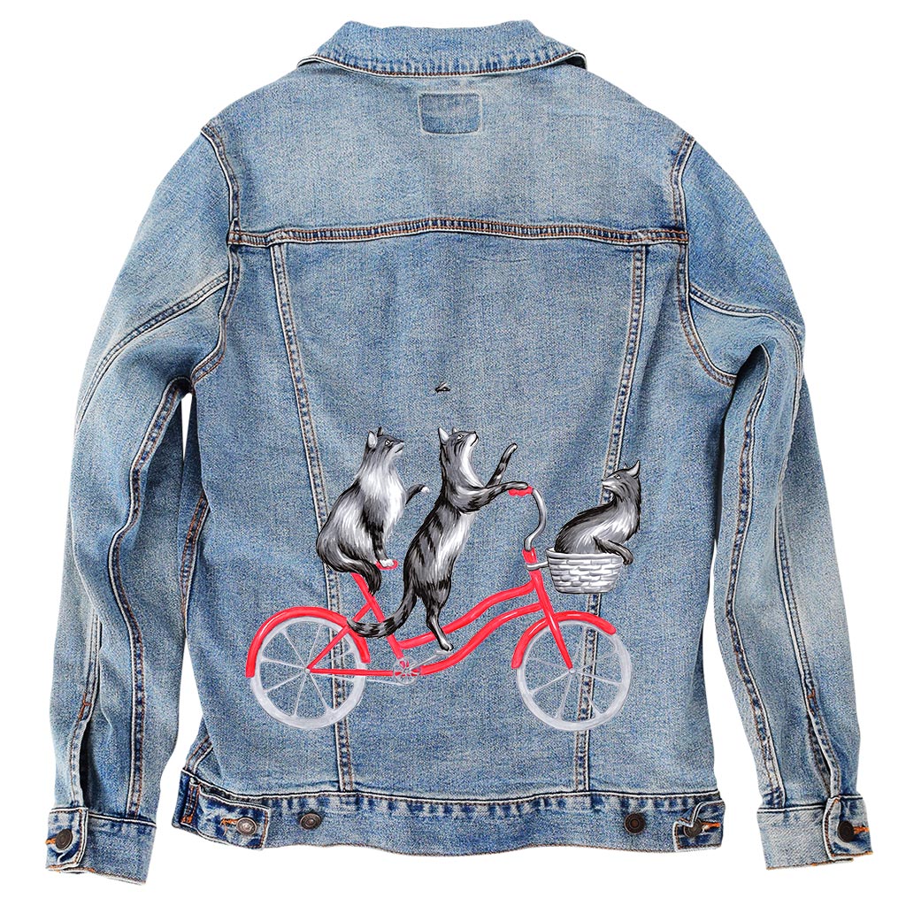 CATS RIDING A BICYCLE by AMELIA LEGAULT, digitally printed on DENIM products: throw pillows, aprons, table place mats, and hand-made Unisex Denim Jackets in 3 color choices
