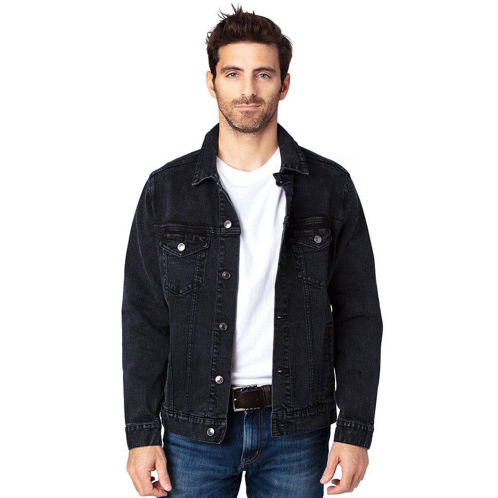 front view of a  model standing in a studio wearing a open plain black unisex retail-fit style classic-cut denim jacket showing buttons, front pockets, stitching and clean print panel with no artwork