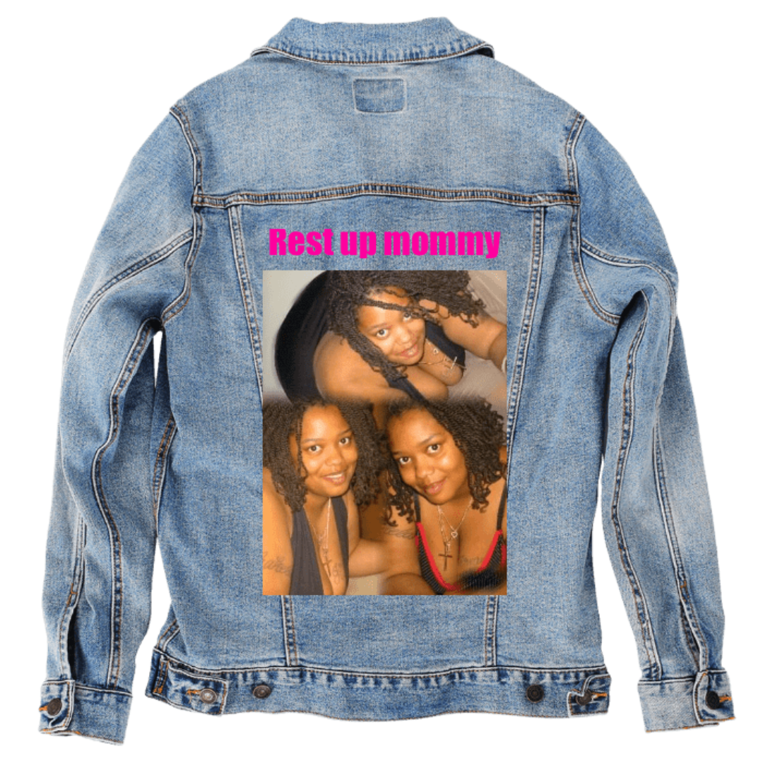 Customer designed custom denim jacket (2XL stonewash) featuring bold pink lettering reading “Rest up mommy” across the upper back. Below it, a warm portrait collage shows the same woman in two softly lit poses, her curly hair framed by gentle highlights and her skin glowing under warm indoor light. She wears layered necklaces and colorful straps, with golden tones and soft shadows giving the images a tender, memorial feel. The vivid pink text and intimate portraits contrast against the rugged stonewash deni