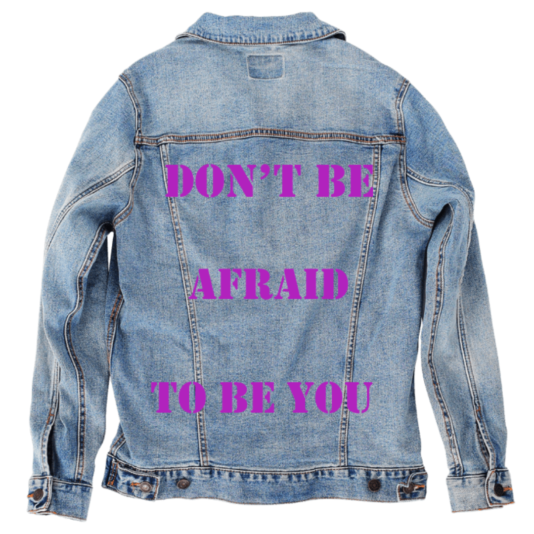 Customer designed custom denim jacket (M stonewash) featuring bold inspirational text printed in vibrant purple stencil-style lettering that reads “DON’T BE AFRAID TO BE YOU” across the back in three stacked lines. The bright, confident typography stands out against the soft, faded blue denim, creating an empowering statement piece with strong visual impact, printed on denim jacket by DenimINK.
