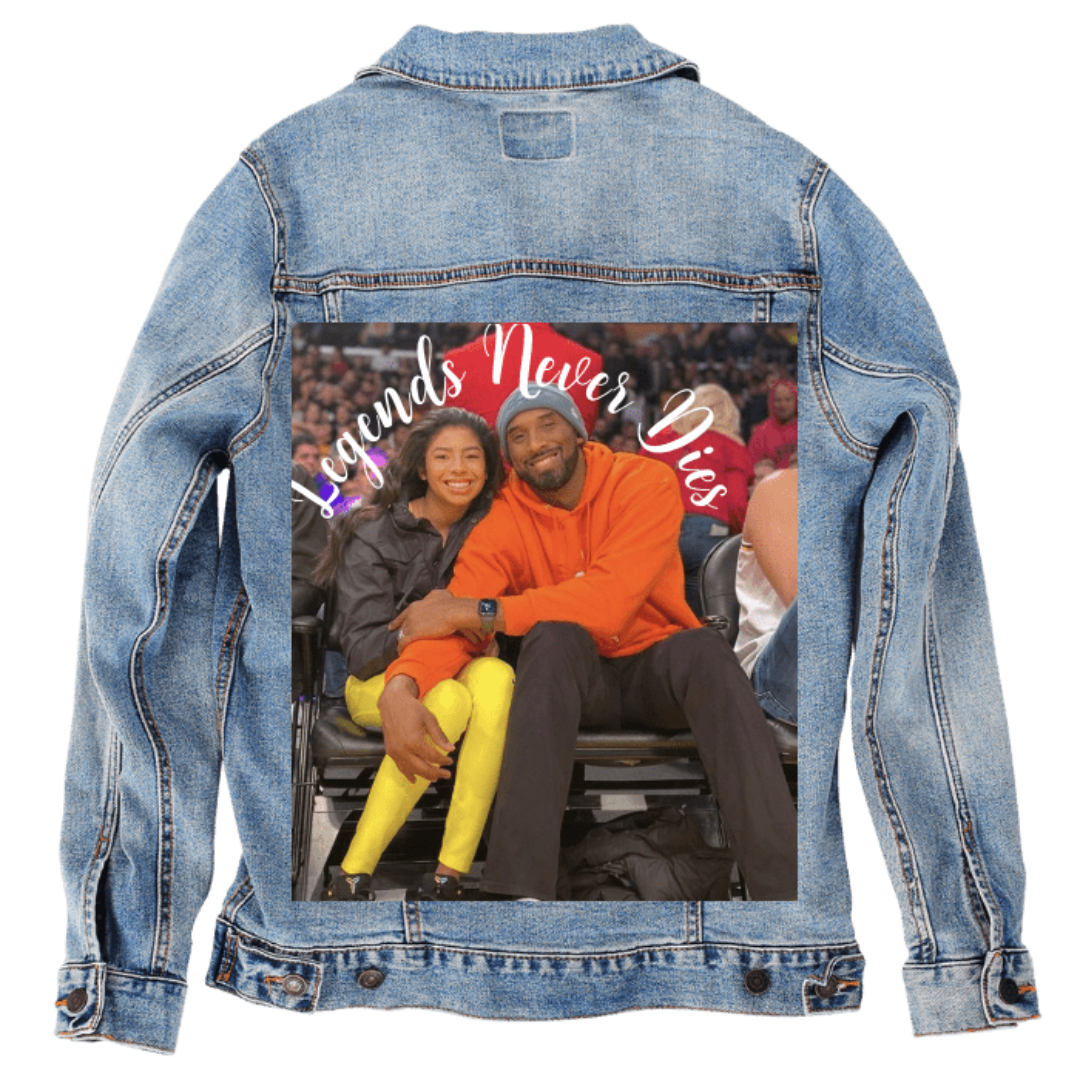 Customer designed custom denim jacket (M stonewash) featuring a full-color photo printed on the back of a man and a girl sitting courtside, smiling with their arms around each other. Above them, in bright curved script, the phrase “Legends Never Dies” appears in white with subtle gradient accents. The warm, emotional scene and inspirational text create a heartfelt tribute-style design that contrasts with the soft, faded blue denim, printed on denim jacket by DenimINK.