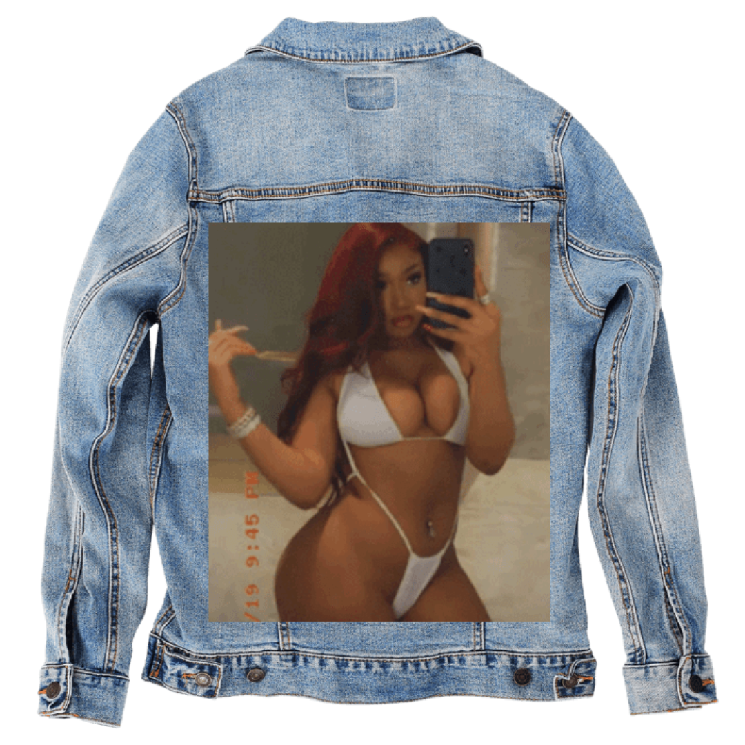 Customer designed custom denim jacket (M stonewash) featuring a full-color mirror selfie printed on the back, showing a woman with long red hair posing in a white bikini, holding a smartphone as she captures the photo. Warm lighting and a soft indoor background give the image a candid, stylized feel, with a timestamp visible along the side. The vivid portrait contrasts sharply against the faded blue denim, printed on denim jacket by DenimINK.