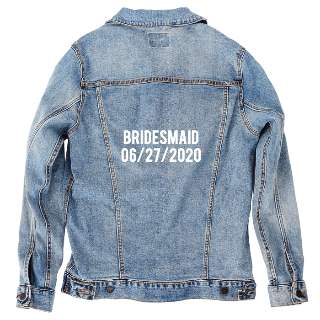 Customer designed custom denim jacket (S stonewash) featuring bold white stencil-style lettering across the back that reads “BRIDESMAID” above the date “06/27/2020.” The crisp block text pops against the soft, faded blue denim, creating a personalized wedding-themed design that feels celebratory and meaningful, printed on denim jacket by DenimINK.