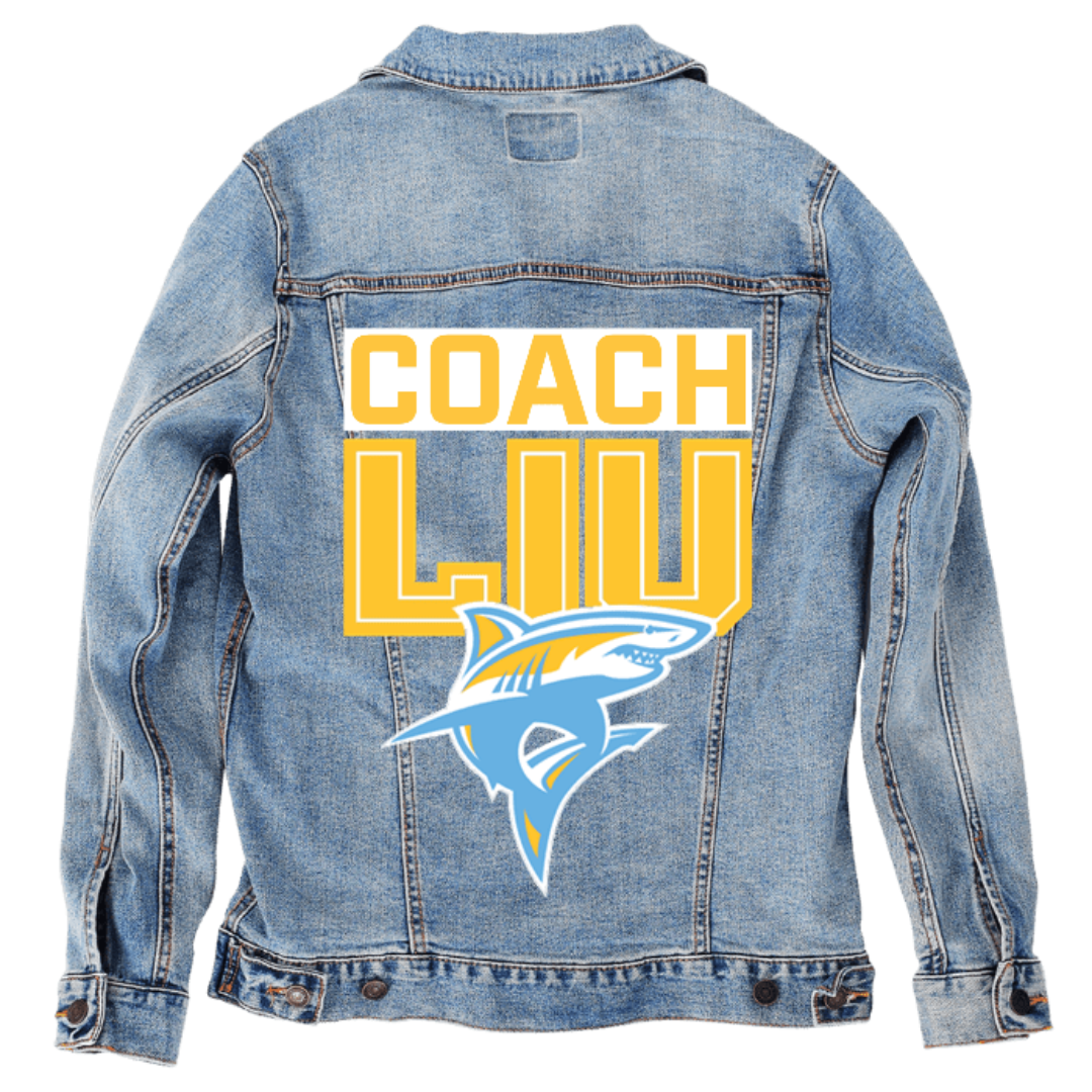 Customer designed custom denim jacket (S stonewash) featuring bold yellow block lettering that reads “COACH” above large yellow “LIU” text, paired with a stylized shark mascot graphic printed below. The sharp angles, bright colors, and sporty layout create an energetic, athletic-inspired design that stands out against the soft, faded blue denim, giving the jacket a strong team-spirited appearance, printed on denim jacket by DenimINK.