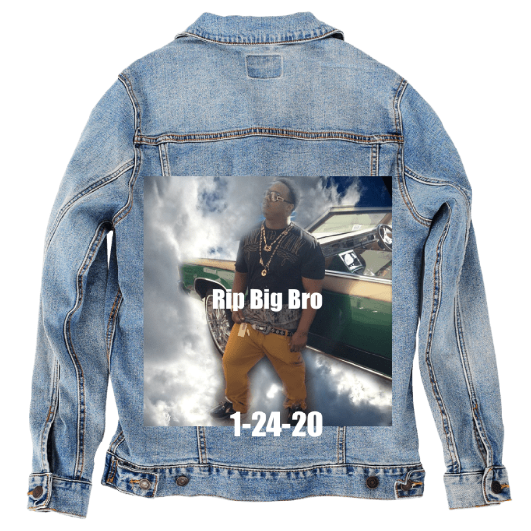 Customer designed custom denim jacket (S stonewash) featuring a memorial-style photo printed on the back, showing a man standing in front of a classic car surrounded by dramatic cloud imagery, with bold white text reading “Rip Big Bro” above and “1-24-20” below. The combination of sky-like effects, symbolic lettering, and reflective tones creates a heartfelt tribute design against the soft, faded blue denim, printed on denim jacket by DenimINK.