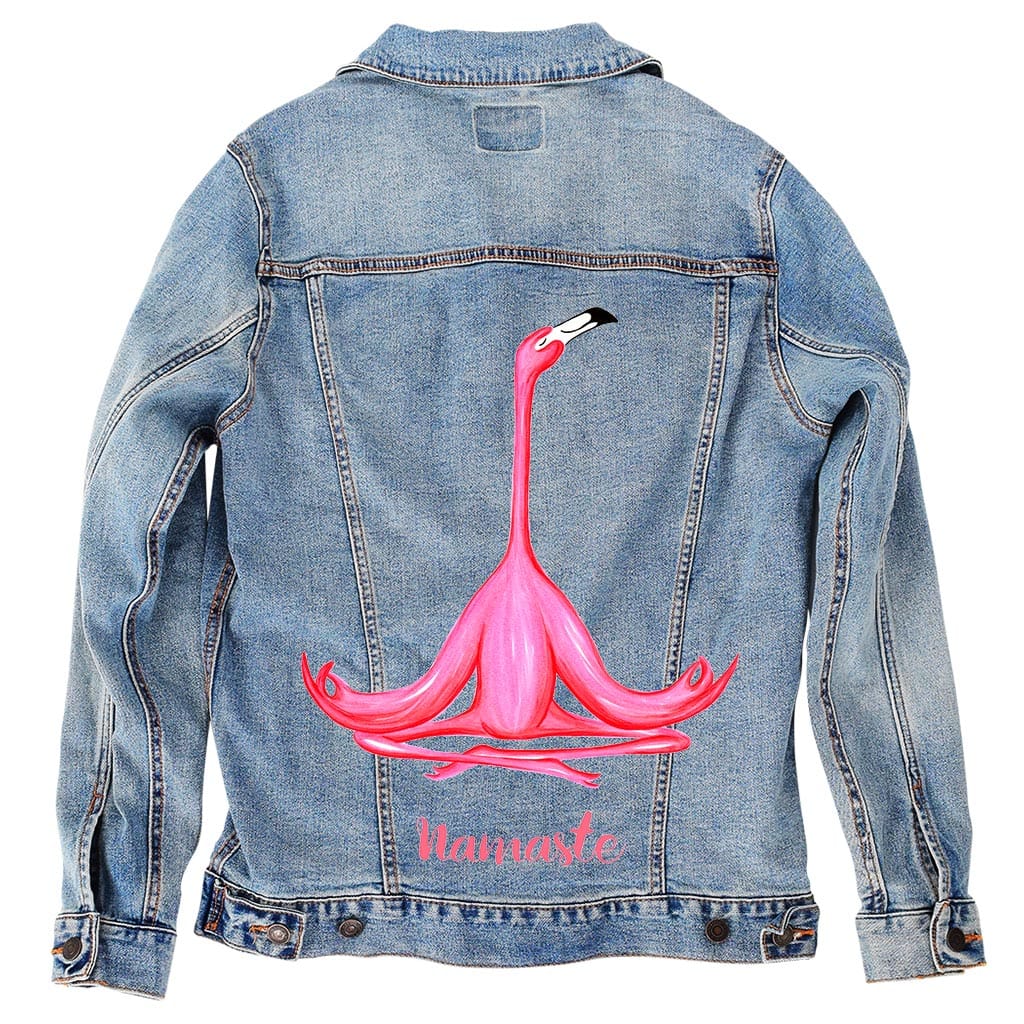 back view of a stonewash denim jacket featuring the artwork “Pink Flamingo Meditating Namaste” by Amelia Legault, showing a pink flamingo in a seated yoga pose with the word “namaste” below it. the artwork is digitally printed on the jacket’s back panel by DenimINK
